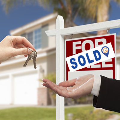 Real Estate Agent Handing Over House Keys in Front of New Home